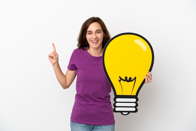 Young caucasian woman isolated on white background holding a bulb icon and thinking