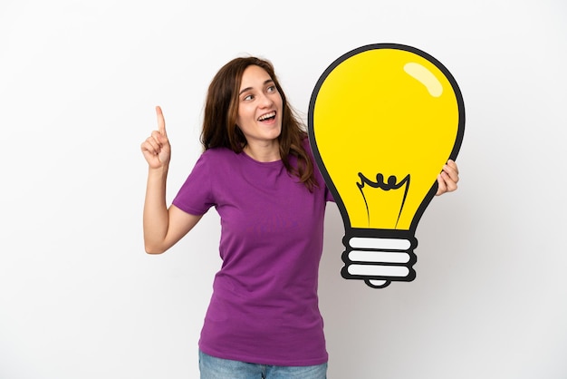 Young caucasian woman isolated on white background holding a bulb icon and thinking