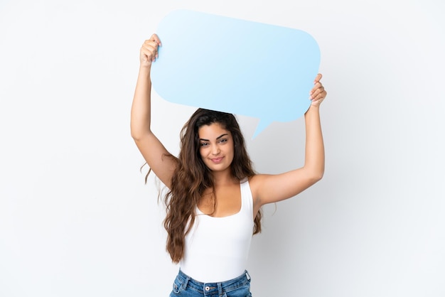 Young caucasian woman isolated on white background holding an empty speech bubble