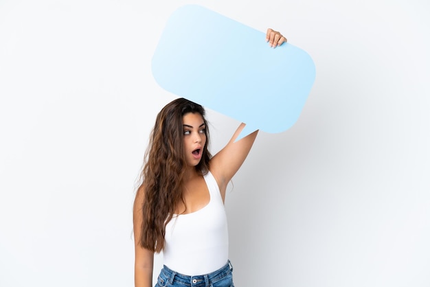 Young caucasian woman isolated on white background holding an empty speech bubble