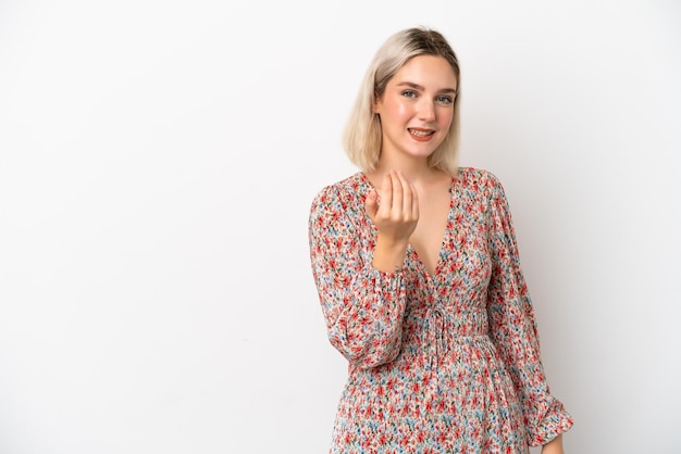 Young caucasian woman isolated on white background inviting to come with hand Happy that you came