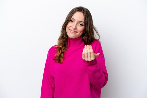 Young caucasian woman isolated on white background inviting to come with hand Happy that you came