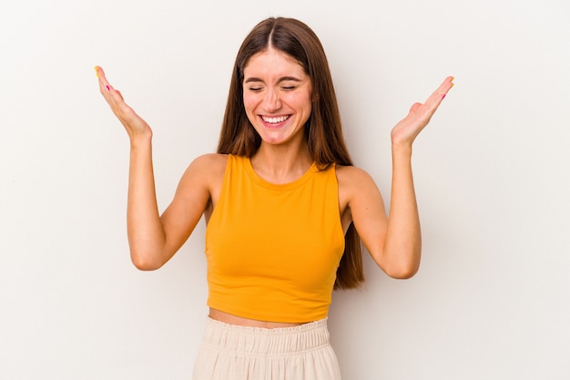 Young caucasian woman isolated on white background joyful laughing a lot. Happiness concept.