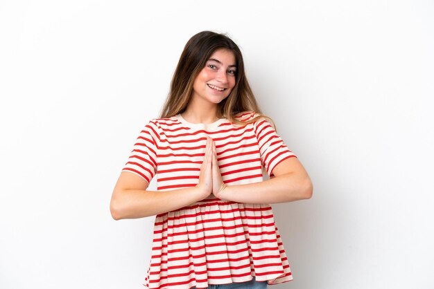 Young caucasian woman isolated on white background keeps palm together Person asks for something