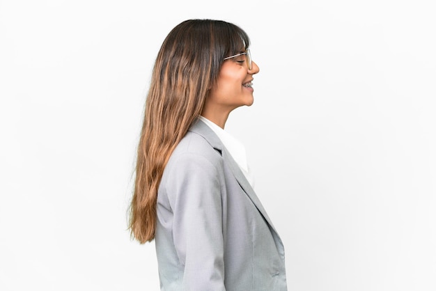 Young caucasian woman over isolated white background laughing in lateral position