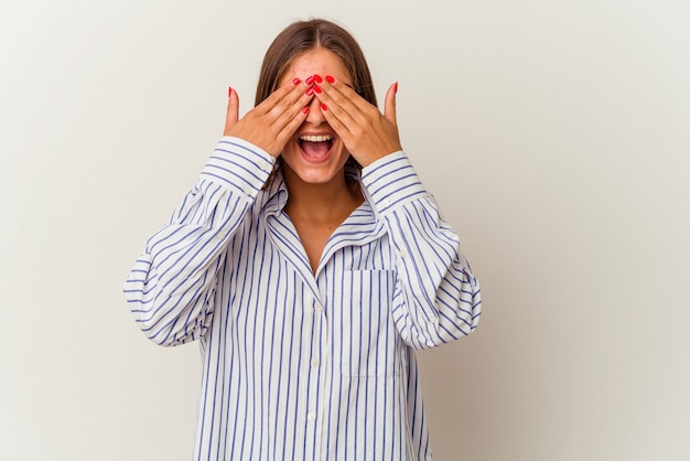 Young caucasian woman isolated on white background laughs out loudly keeping hand on chest.