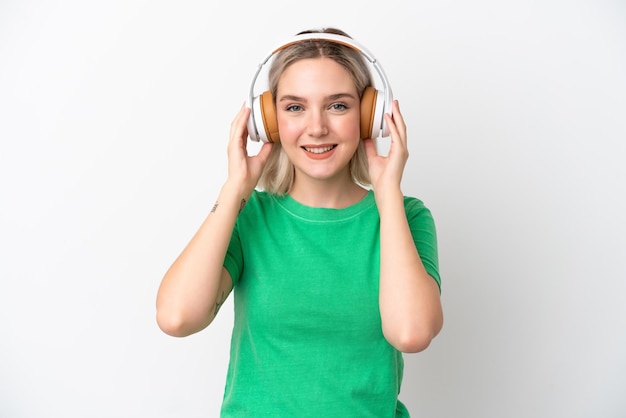 Young caucasian woman isolated on white background listening music