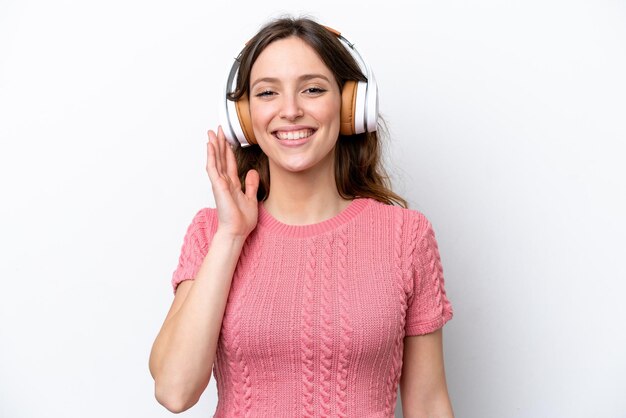 Young caucasian woman isolated on white background listening music