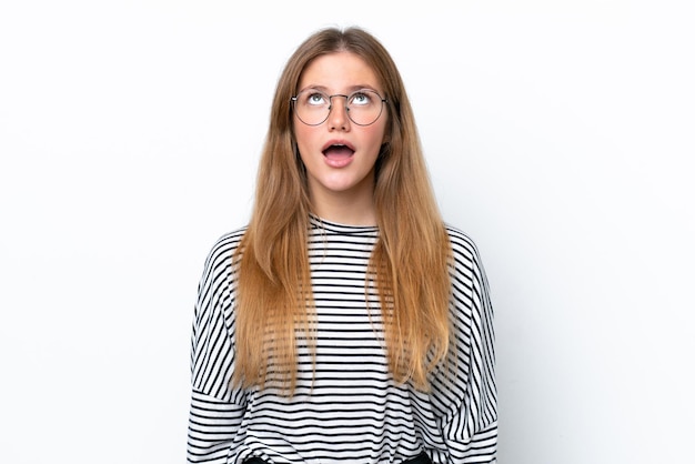 Young caucasian woman isolated on white background looking up and with surprised expression