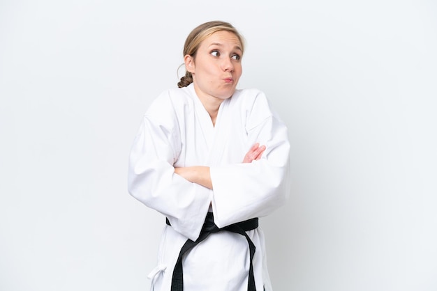 Young caucasian woman isolated on white background making doubts gesture while lifting the shoulders