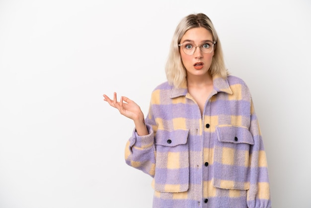 Young caucasian woman isolated on white background making doubts gesture