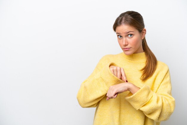 Young caucasian woman isolated on white background making the gesture of being late