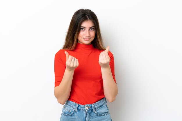 Young caucasian woman isolated on white background making money gesture but is ruined