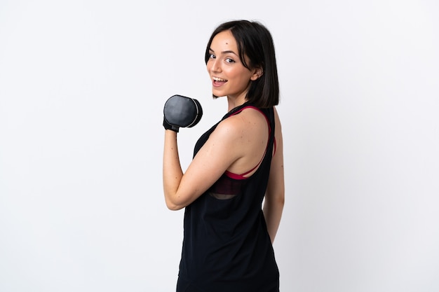 Young caucasian woman isolated on white background making weightlifting