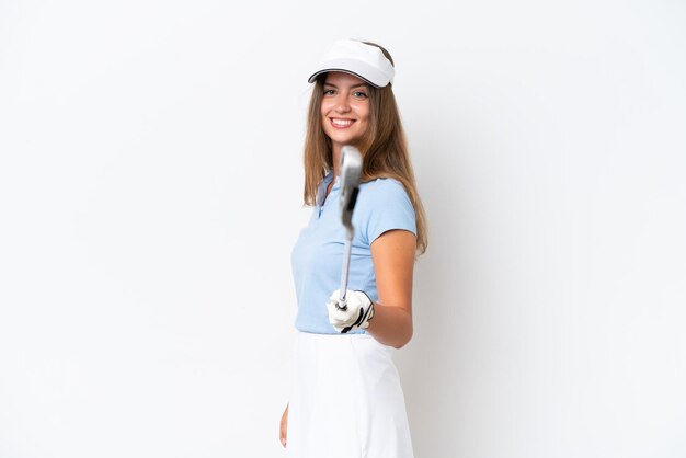 Young caucasian woman isolated on white background playing golf