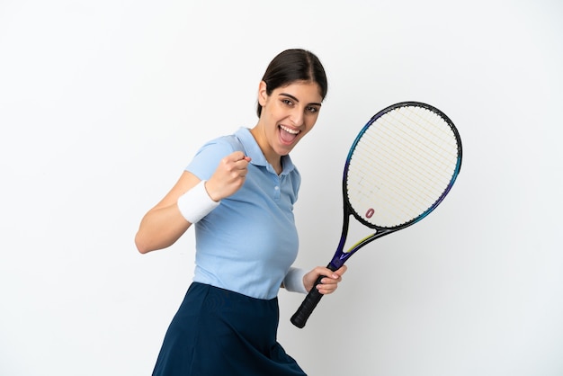 Young caucasian woman isolated on white background playing tennis and celebrating a victory