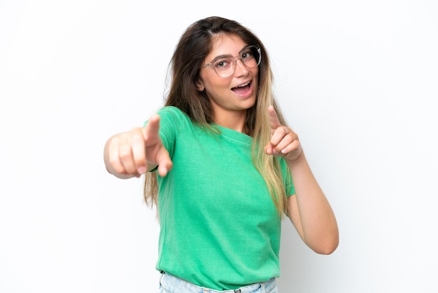 Young caucasian woman isolated on white background pointing front with happy expression