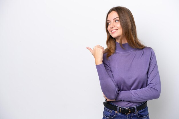 Young caucasian woman isolated on white background pointing to the side to present a product