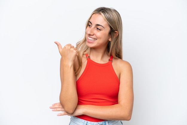 Young caucasian woman isolated on white background pointing to the side to present a product