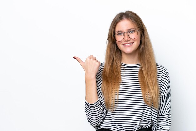 Young caucasian woman isolated on white background pointing to the side to present a product