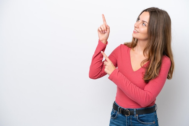 Young caucasian woman isolated on white background pointing with the index finger a great idea