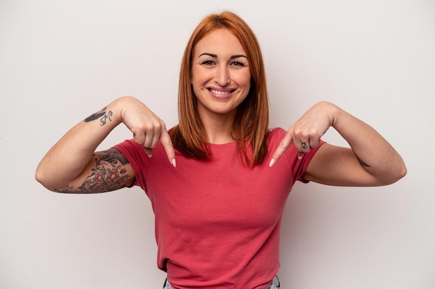 Young caucasian woman isolated on white background points down with fingers, positive feeling.