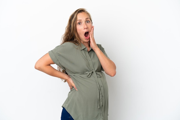 Young caucasian woman isolated on white background pregnant and doing surprise gesture