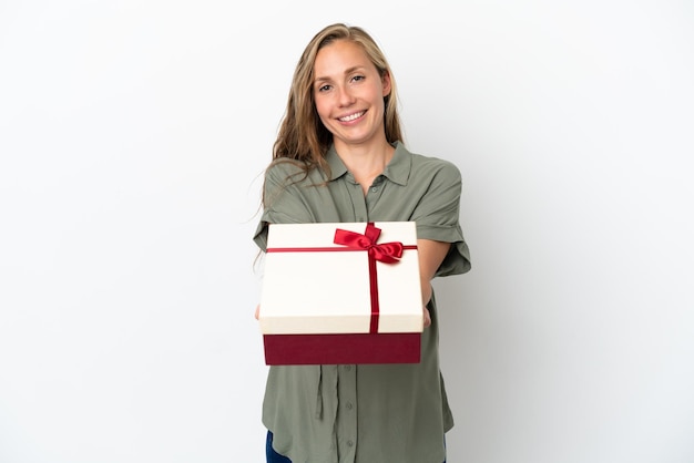 Young caucasian woman isolated on white background pregnant and holding a gift