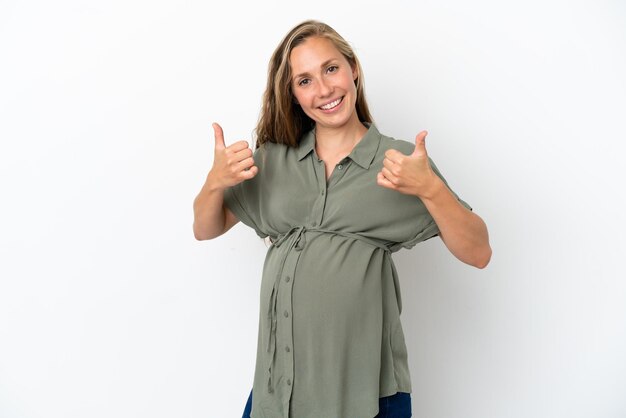 Young caucasian woman isolated on white background pregnant and with thumb up