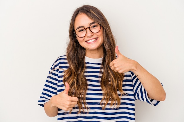 Young caucasian woman isolated on white background raising both thumbs up, smiling and confident.