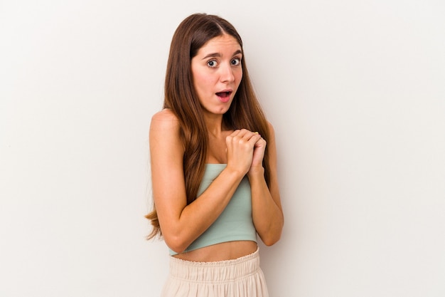 Young caucasian woman isolated on white background scared and afraid.