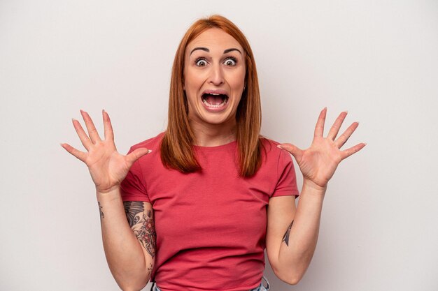 Young caucasian woman isolated on white background screaming to the sky looking up frustrated