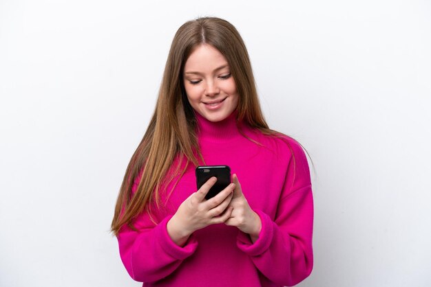 Young caucasian woman isolated on white background sending a message with the mobile