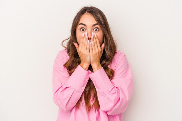 Young caucasian woman isolated on white background shocked, covering mouth with hands, anxious to discover something new.