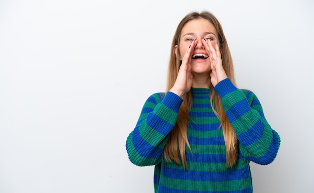 Young caucasian woman isolated on white background shouting and announcing something