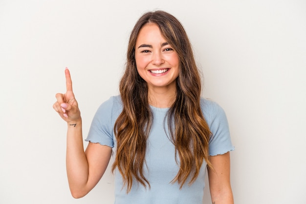 Young caucasian woman isolated on white background showing number one with finger.