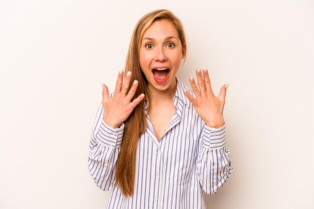 Young caucasian woman isolated on white background showing number ten with hands