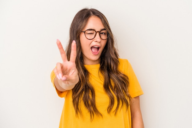 Young caucasian woman isolated on white background showing number two with fingers.