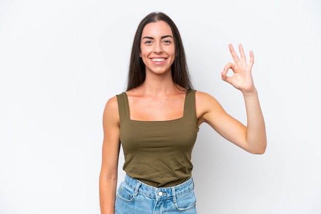 Young caucasian woman isolated on white background showing ok sign with fingers