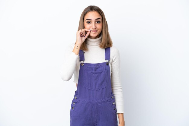 Young caucasian woman isolated on white background showing a sign of silence gesture