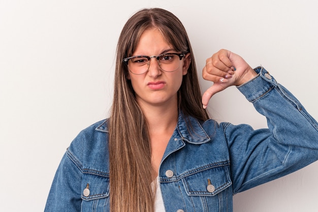 Young caucasian woman isolated on white background showing thumb down, disappointment concept.