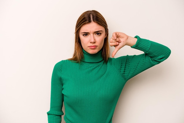 Young caucasian woman isolated on white background showing thumb down disappointment concept