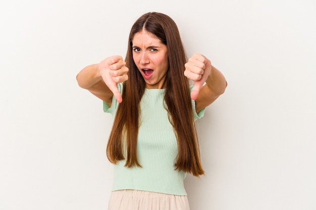 Young caucasian woman isolated on white background showing thumb down and expressing dislike.