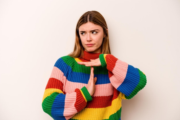 Young caucasian woman isolated on white background showing a timeout gesture