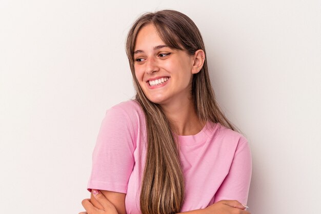 Young caucasian woman isolated on white background smiling confident with crossed arms.