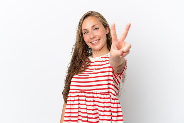 Young caucasian woman isolated on white background smiling and showing victory sign