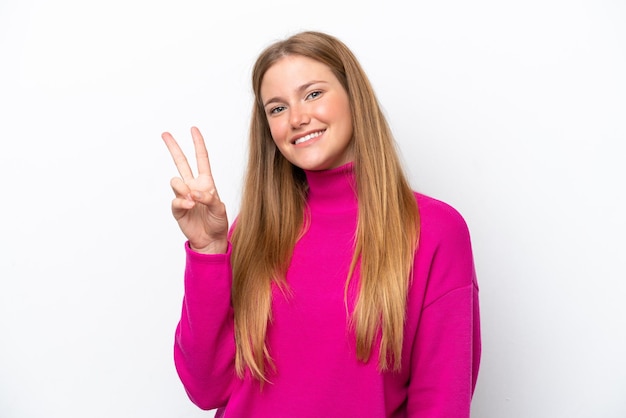 Young caucasian woman isolated on white background smiling and showing victory sign