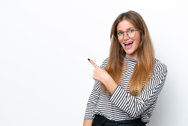 Young caucasian woman isolated on white background surprised and pointing side