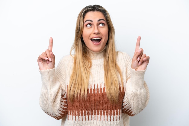 Young caucasian woman isolated on white background surprised and pointing up