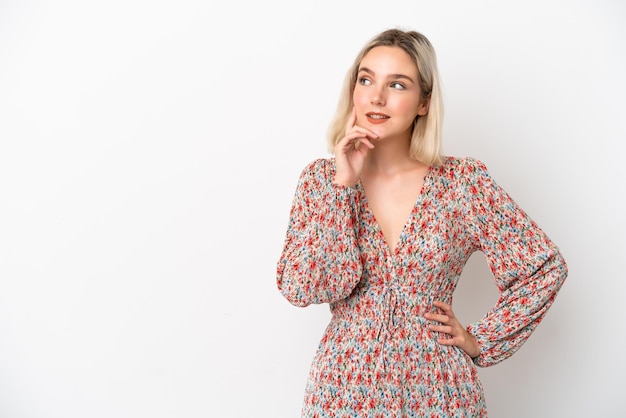 Young caucasian woman isolated on white background thinking an idea while looking up